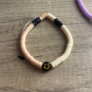 1pc tan,cream, and black clay bracelet with smiley charm (handmade).